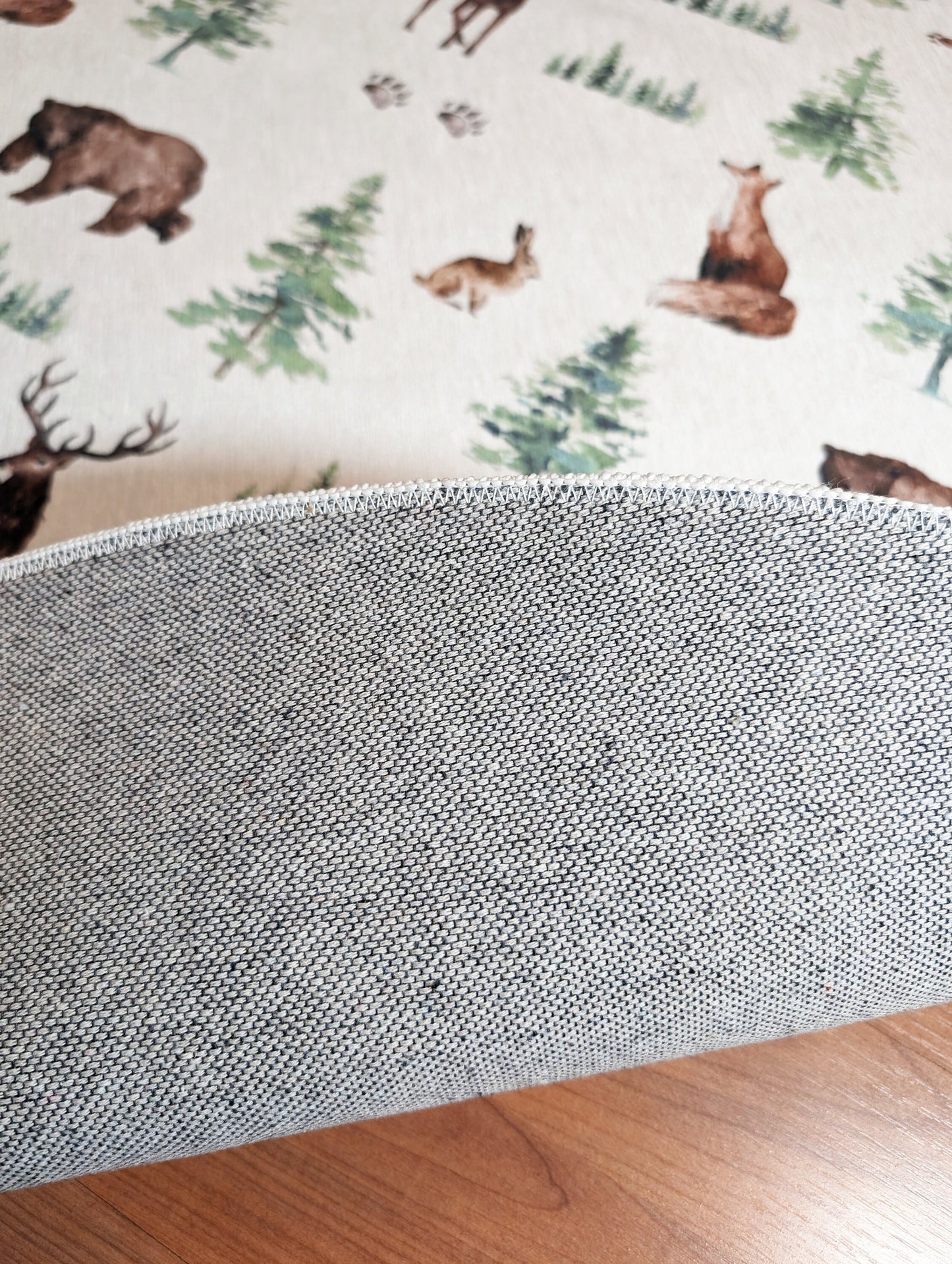 a close up of a pillow on a wooden floor